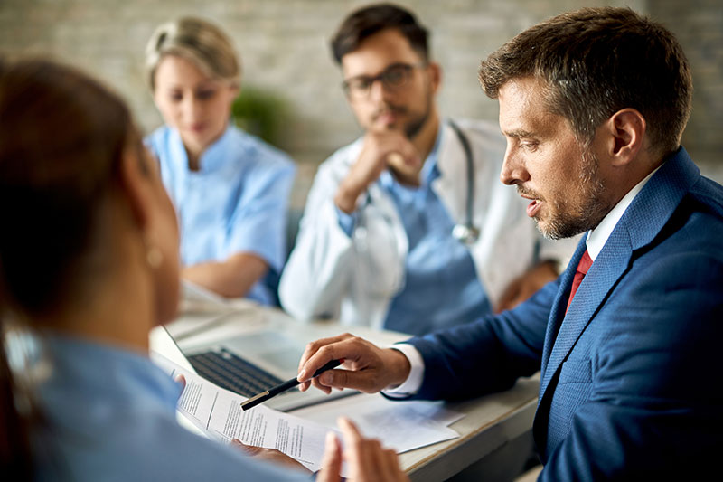 mid-adult-businessman-healthcare-workers-analyzing-documents-during-meeting-office-8.jpg